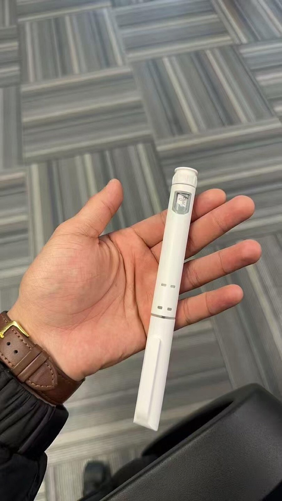 Compact white pen injector sample held for size review