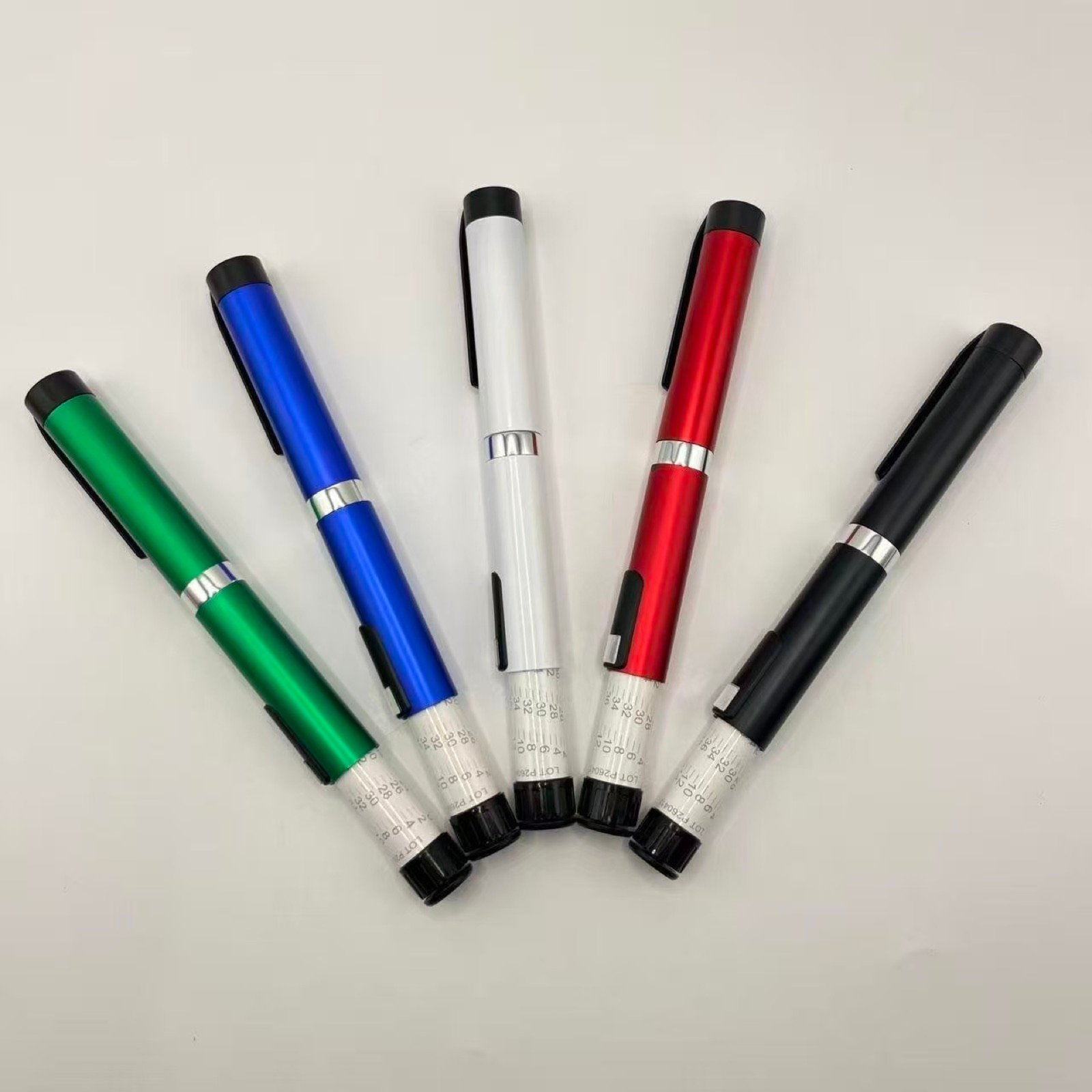 Five customized metal pen injector samples arranged in a fan