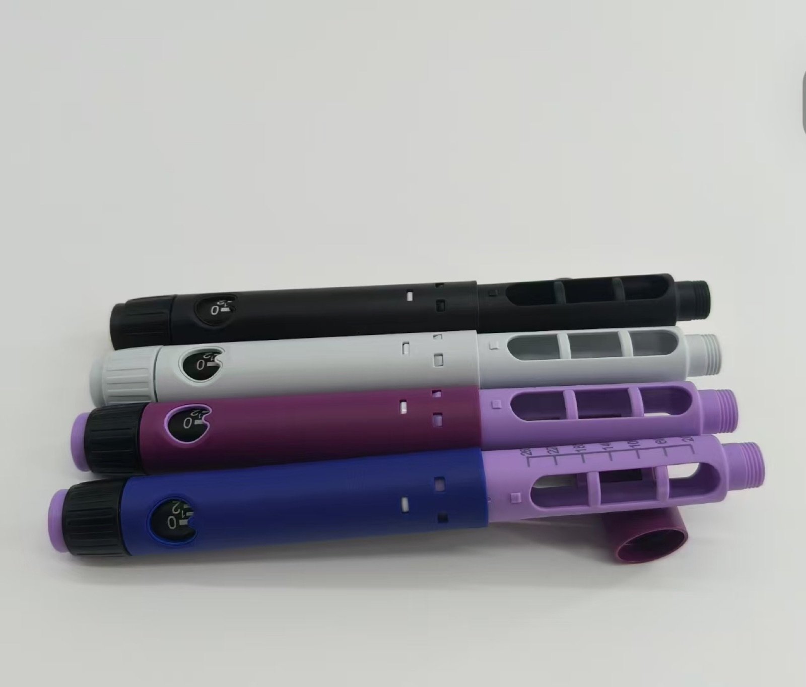 Plastic pen injector body structures in four color combinations